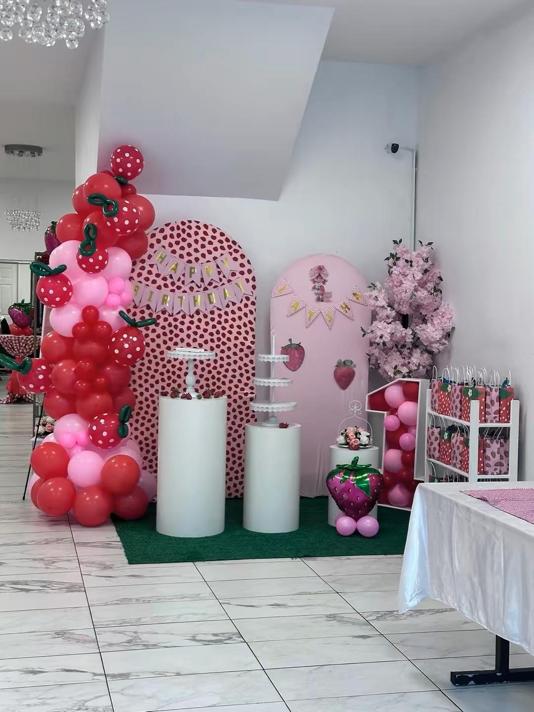 First birthday community celebration with balloon arch and dessert displays at Elegance on Varet