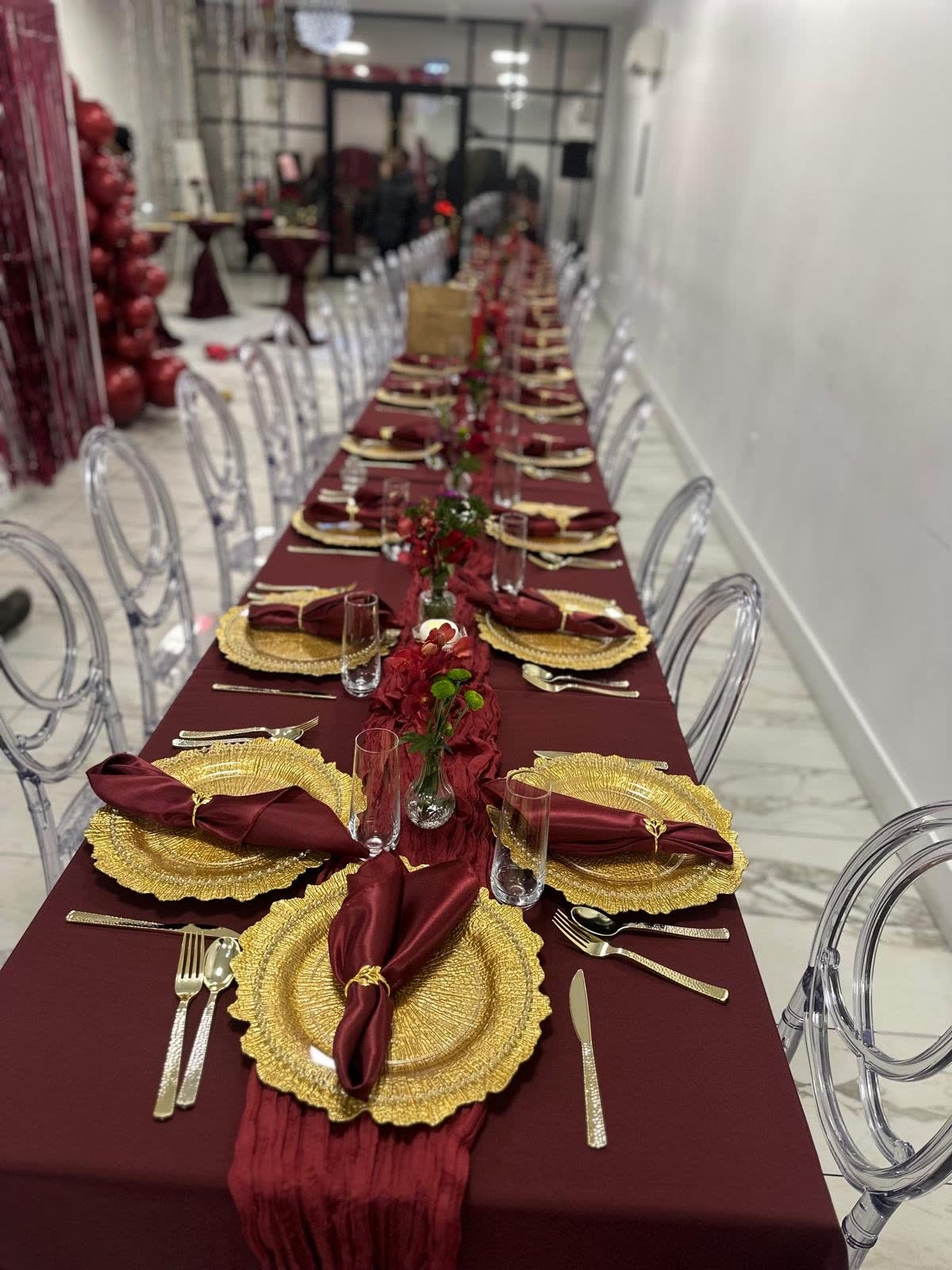 Burgundy long-table dinner with gold place settings at Elegance on Varet