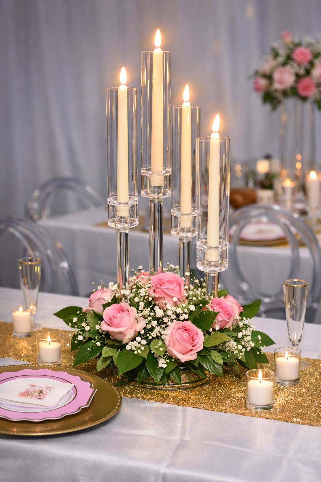 Wedding reception table set with candles, gold accents and pink roses at Elegance on Varet