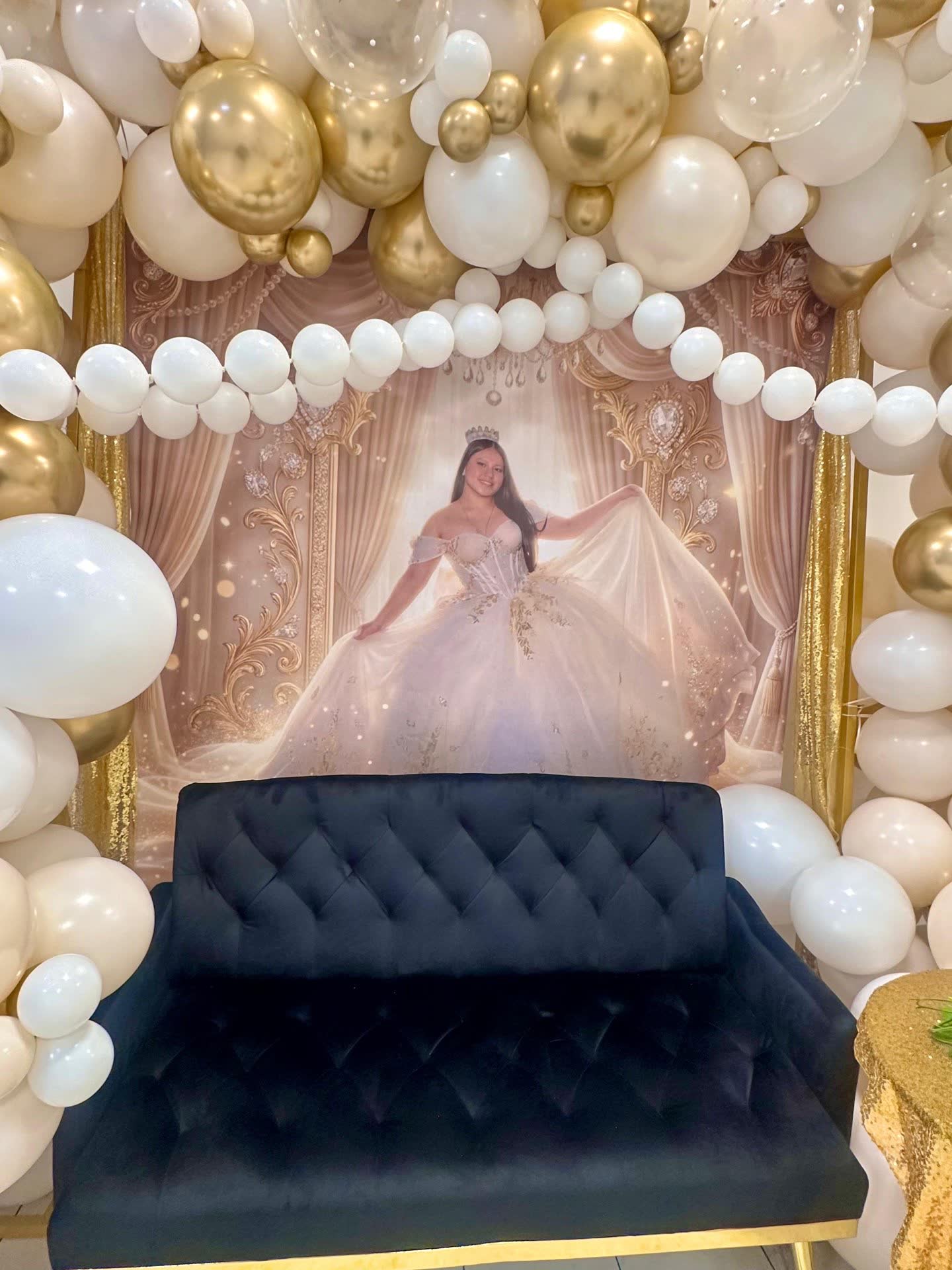 Gold and white birthday balloon backdrop with lounge seating at Elegance on Varet